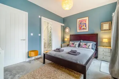 a bedroom with a large bed with blue walls at 2 Bed in Bentley oc-thpo in Bentley