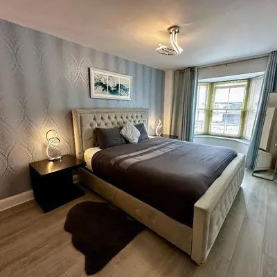 a bedroom with a large bed and a window at One Bedroom Flat Town Centre Colchester in Colchester