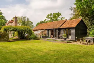 a barn conversion with a garden and a house at The Lodge, Wherstead in Wherstead