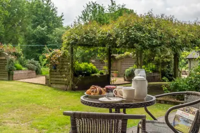 a table with a plate of food on a patio at The Lodge, Wherstead in Wherstead