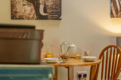 a wooden table with glasses of orange juice on it at The Lodge, Wherstead in Wherstead