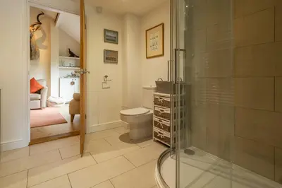 a bathroom with a toilet and a glass shower at The Lodge, Wherstead in Wherstead