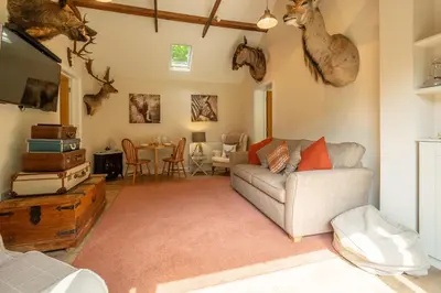 a living room with a couch and a table at The Lodge, Wherstead in Wherstead