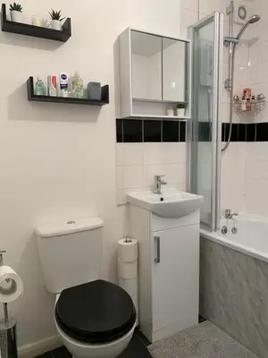 a white bathroom with a toilet and a sink at Modern Cosy Warm Home With Free Parking in Chelmsford