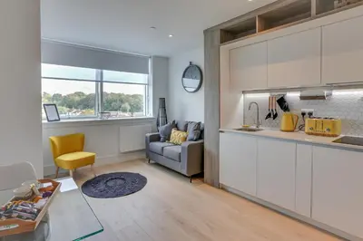 a kitchen and a living room with a couch at Kings Road Apartments in Brentwood
