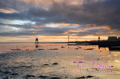 two people walking on the beach at sunset at Seaview B&B in Harwich