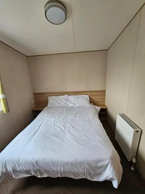 a bedroom with a large white bed in it at Exquisite holidays letting for 3 nights starting from £90 in Jaywick Sands