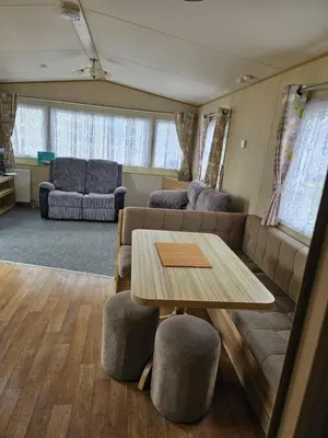 a living room with a couch and a table and chairs at Exquisite holidays letting for 3 nights starting from £90 in Jaywick Sands