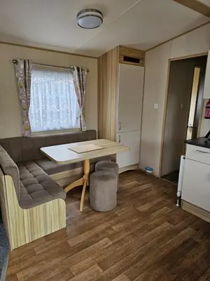 a small room with a table and a couch at Exquisite holidays letting for 3 nights starting from £90 in Jaywick Sands