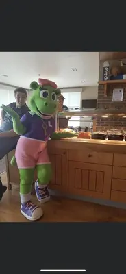 a person wearing a green mascot in a kitchen at DaisyChain 2 Getaways - The perfect place to Stay - Play - Getaway in East Mersea