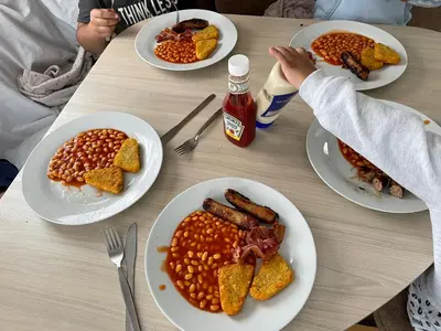 a table with four plates of food on it at La Casa Greenaway in Jaywick Sands