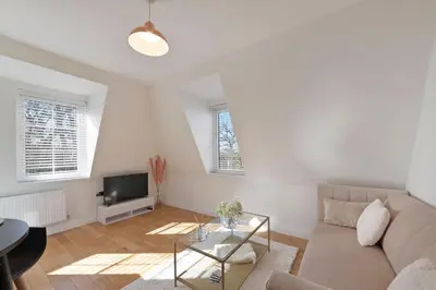 a living room with a couch and a tv at Spacious One Bed loft Apartment in Birchanger