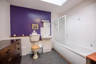 a bathroom with a toilet and a sink and a shower at The Woodshed, Benhall in Saxmundham