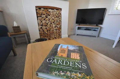 a book sitting on a table in a living room at Corner Cottage in Cambridge