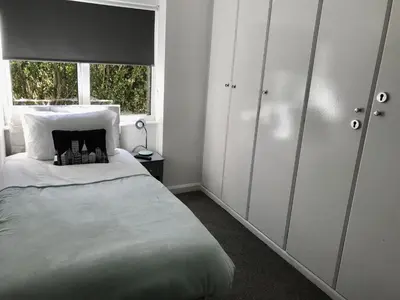 a bedroom with a large bed and a window at Stanford Villa in Stanford le Hope