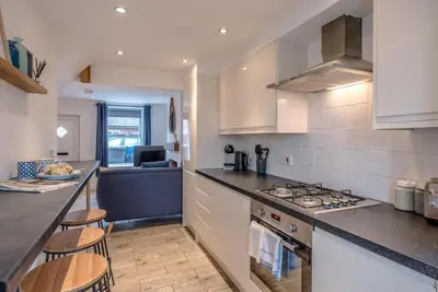 a kitchen with a counter and a stove top oven at Lily Cottage, Leiston in Leiston
