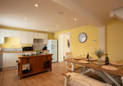 a kitchen with a table and a dining room at City to Country Retreat Luxury Cottage with Hot Tub in Toppesfield
