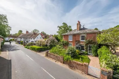 a brick house on the side of a street at Adorable cottage with a log burner in heavenly village - Constable Lodge in Nayland