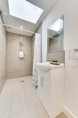 a white bathroom with a sink and a shower at 3 Bed in Great Waldingfield oc-ac2 in Great Waldingfield