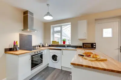 a kitchen with white appliances and a wooden counter top at 3 Bed in Great Waldingfield oc-ac2 in Great Waldingfield