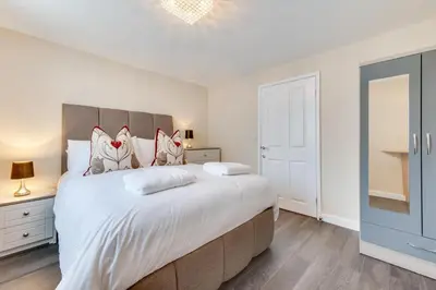 a bedroom with a large bed and a tv at 3 Bed in Great Waldingfield oc-ac2 in Great Waldingfield