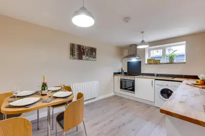 a kitchen and dining room with a table and chairs at 6 Bed in Great Waldingfield oc-ac4 in Great Waldingfield
