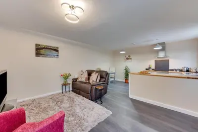 a living room with a couch and a kitchen at 6 Bed in Great Waldingfield oc-ac4 in Great Waldingfield
