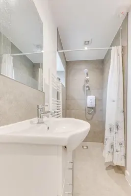 a white bathroom with a sink and a shower at 6 Bed in Great Waldingfield oc-ac4 in Great Waldingfield