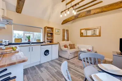 a kitchen and living room with a washer and dryer at 1 Bed in Great Waldingfield oc-ac1 in Great Waldingfield