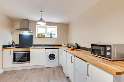 a kitchen with white appliances and a wooden counter top at 2 Bed in Great Waldingfield oc-ac3 in Great Waldingfield