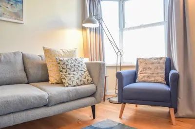 a living room with a couch and a chair at Seaflower, Aldeburgh in Aldeburgh