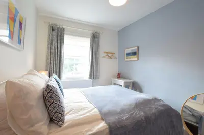 a bedroom with a bed and a window at Seaflower, Aldeburgh in Aldeburgh