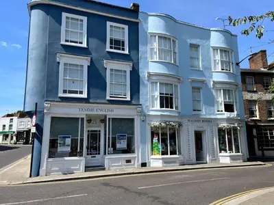 a blue building on the corner of a street at The Tower, 1 bed 1850's Tiny House in Maldon