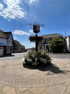 a lamp post with flowers in the middle of a street at The Tower, 1 bed 1850's Tiny House in Maldon
