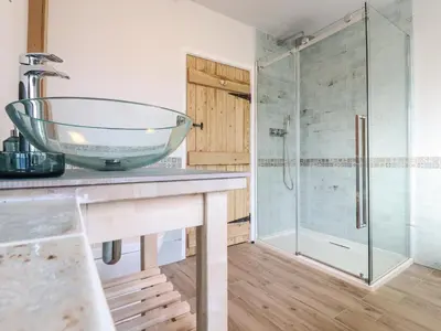 a bathroom with a glass sink and a shower at Bluebird Cottage in Higham
