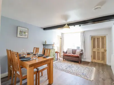 a dining room with a table and chairs at Bluebird Cottage in Higham