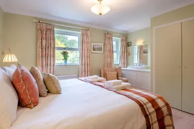a large white bed in a room with a window at 3 Bed in Aldeburgh oc-spcot in Aldeburgh