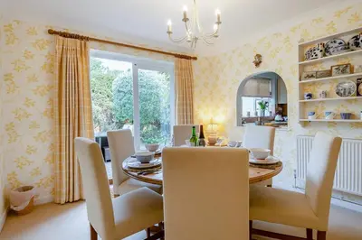 a dining room with a table and chairs and a window at 3 Bed in Aldeburgh oc-spcot in Aldeburgh