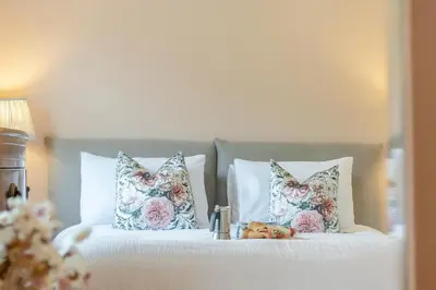 a bed with pillows and a tray of teddy bears on it at 3 Bed in Aldeburgh oc-spcot in Aldeburgh