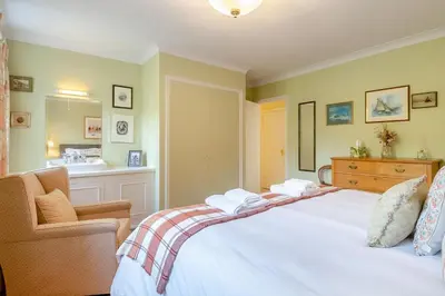 a bedroom with a bed and a chair and a sink at 3 Bed in Aldeburgh oc-spcot in Aldeburgh