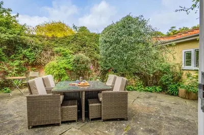 a patio with a table and chairs in a yard at 3 Bed in Aldeburgh oc-spcot in Aldeburgh