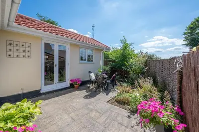 a patio with two chairs in front of a house at 1 Bed in Debach oc-lasn in Debach