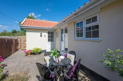 a patio with a table and chairs in front of a house at 1 Bed in Debach oc-lasn in Debach
