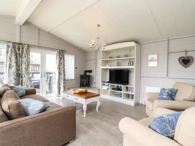 a living room with two couches and a table at Skylarks in Hengrave