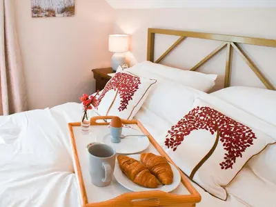 a tray of croissants and coffee on a bed at The Stables in Bealings