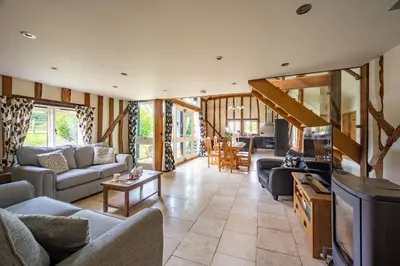 a living room with couches and a tv at Moles Meadow in Middleton