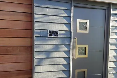 a door to a house with two pictures on it at Lauriston Stay in Birch