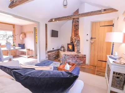 a living room with a couch and a fireplace at The Forge in Stowmarket