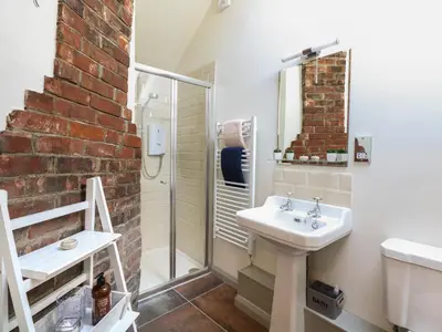 a bathroom with a sink and a shower at The Forge in Stowmarket