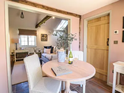 a living room with a table and chairs at The Forge in Stowmarket